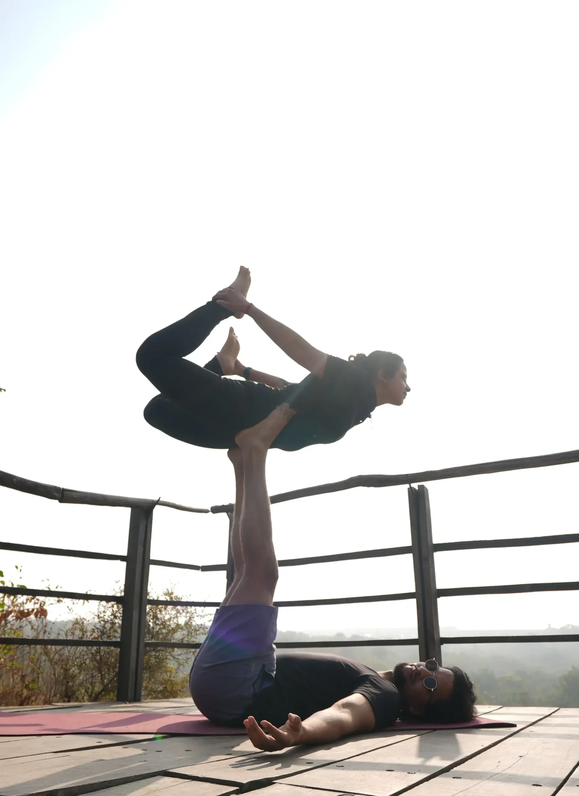 Two people performing AcroYoga, showing community and trust.