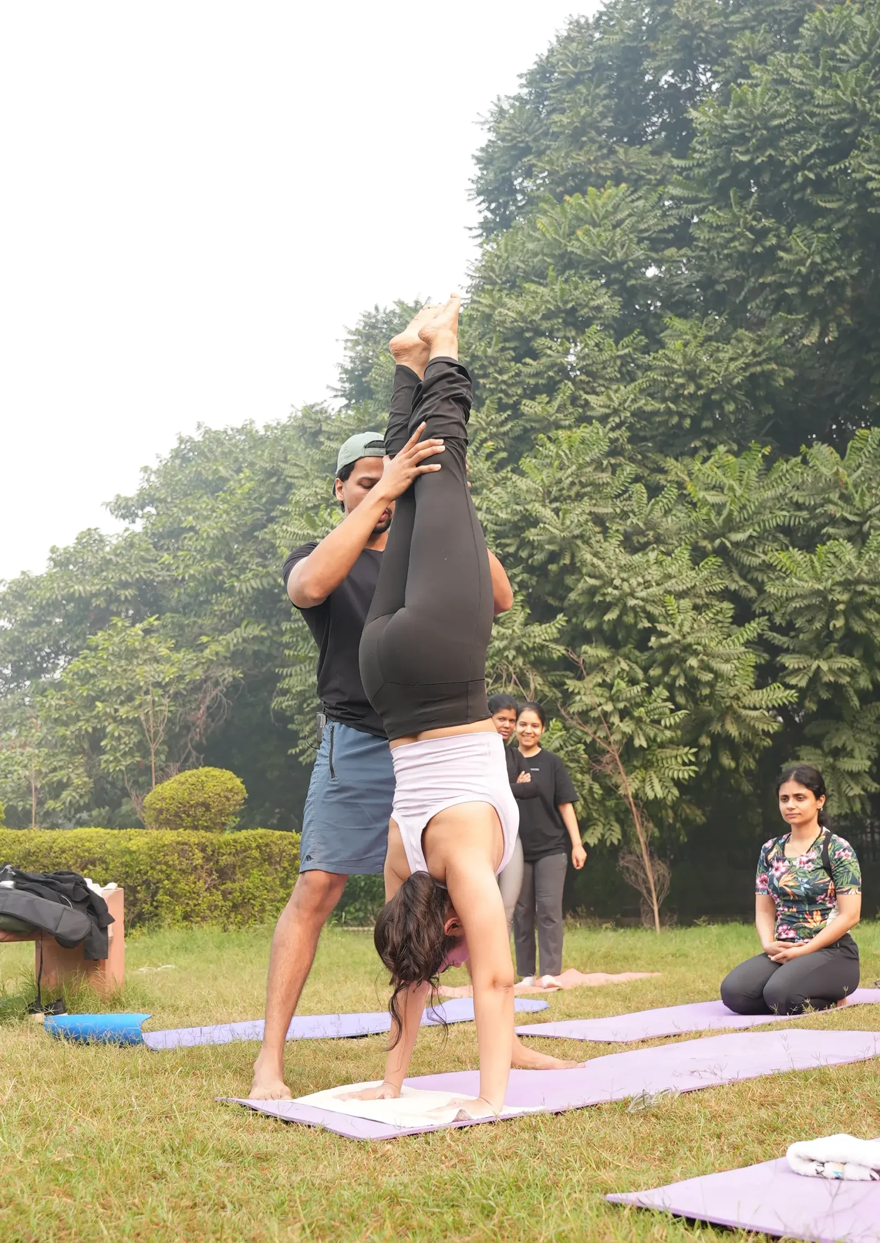 Man holding an advanced yoga pose in the water, showing strength and balance.